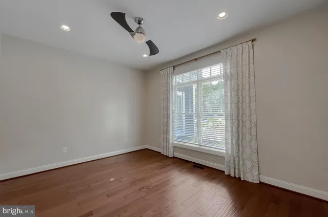 a view of an empty room with a ceiling fan
