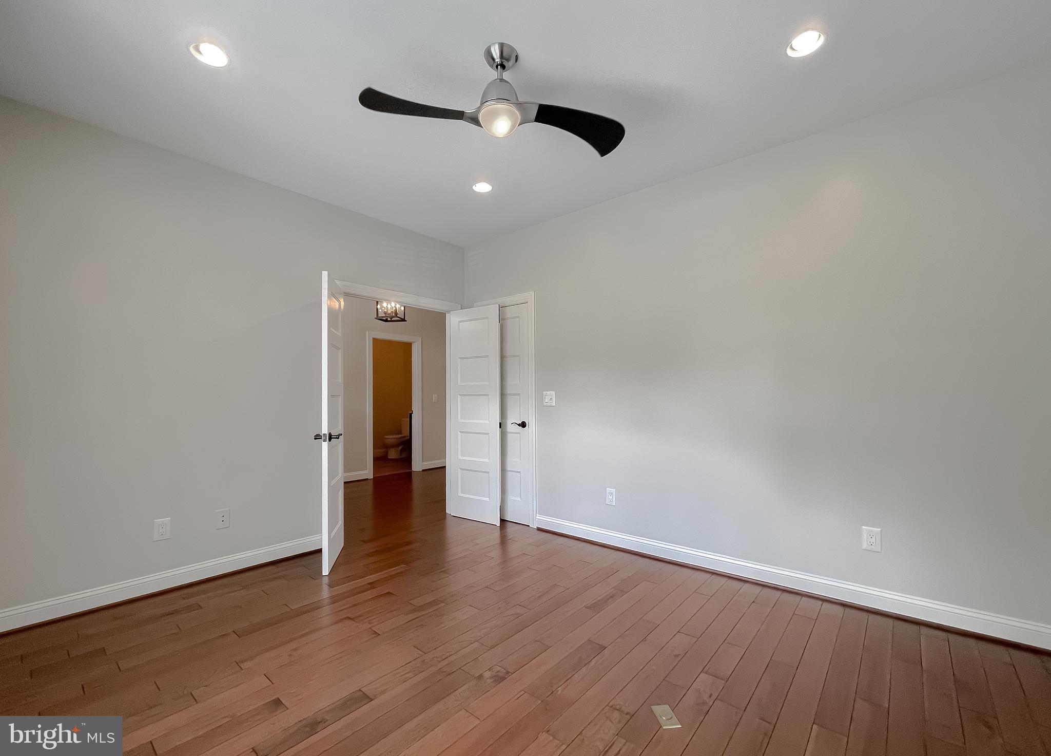 24754 Half Pone Point Road Hollywood, MD 20636 - Photo 35 of 137 an empty room with wooden floor and natural light
