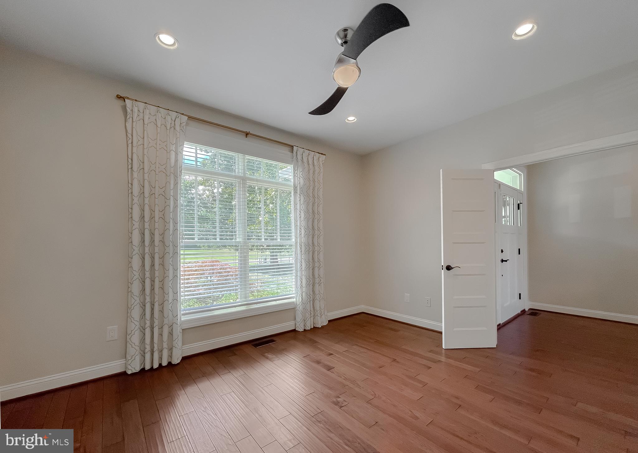 24754 Half Pone Point Road Hollywood, MD 20636 - Photo 36 of 137 an empty room with wooden floor fan and windows