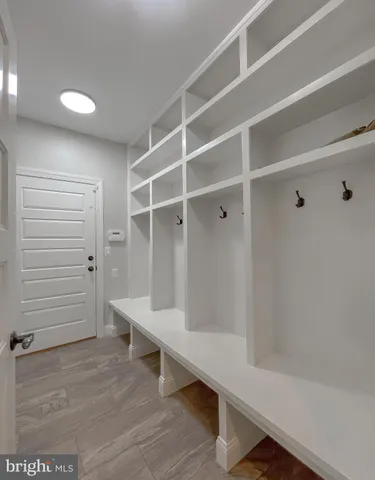 a bathroom with a sink a toilet a large mirror and shower