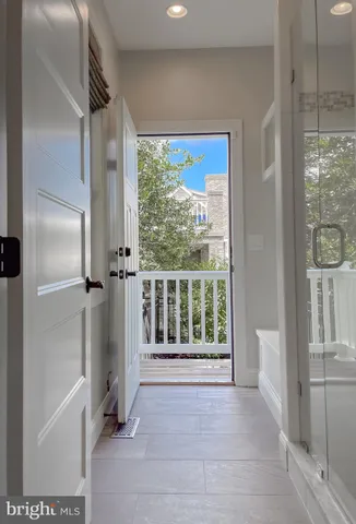 a view of a kitchen with a sink and a refrigerator