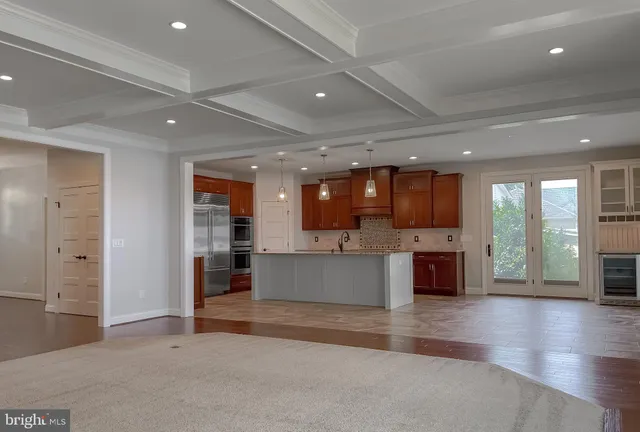 an empty room with closet and a chandelier fan