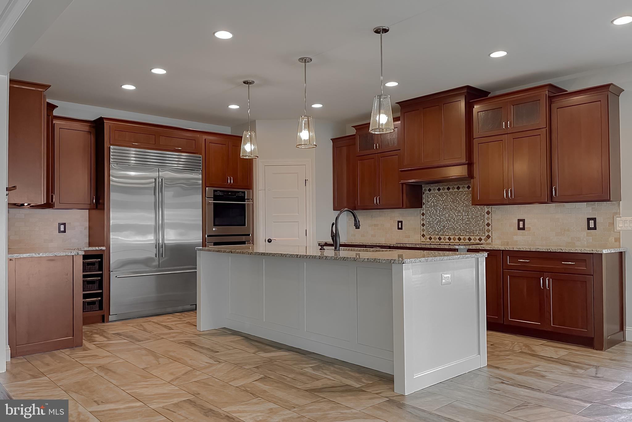 24754 Half Pone Point Road Hollywood, MD 20636 - Photo 54 of 137 a large kitchen with stainless steel appliances kitchen island granite countertop a stove a sink and a refrigerator