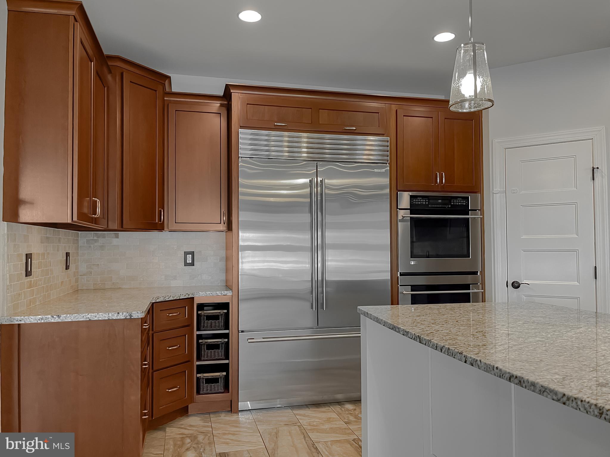 24754 Half Pone Point Road Hollywood, MD 20636 - Photo 55 of 137 a kitchen with stainless steel appliances granite countertop a refrigerator and a sink