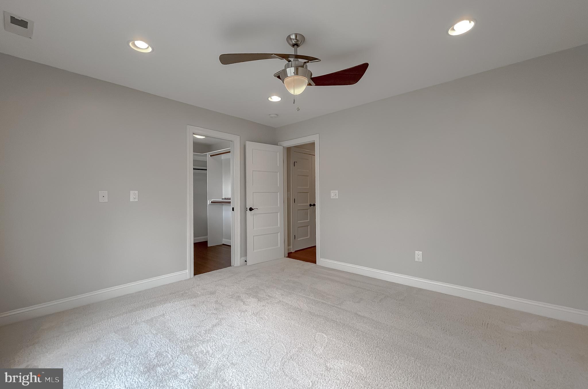 24754 Half Pone Point Road Hollywood, MD 20636 - Photo 70 of 137 an empty room with a ceiling fan and closet area