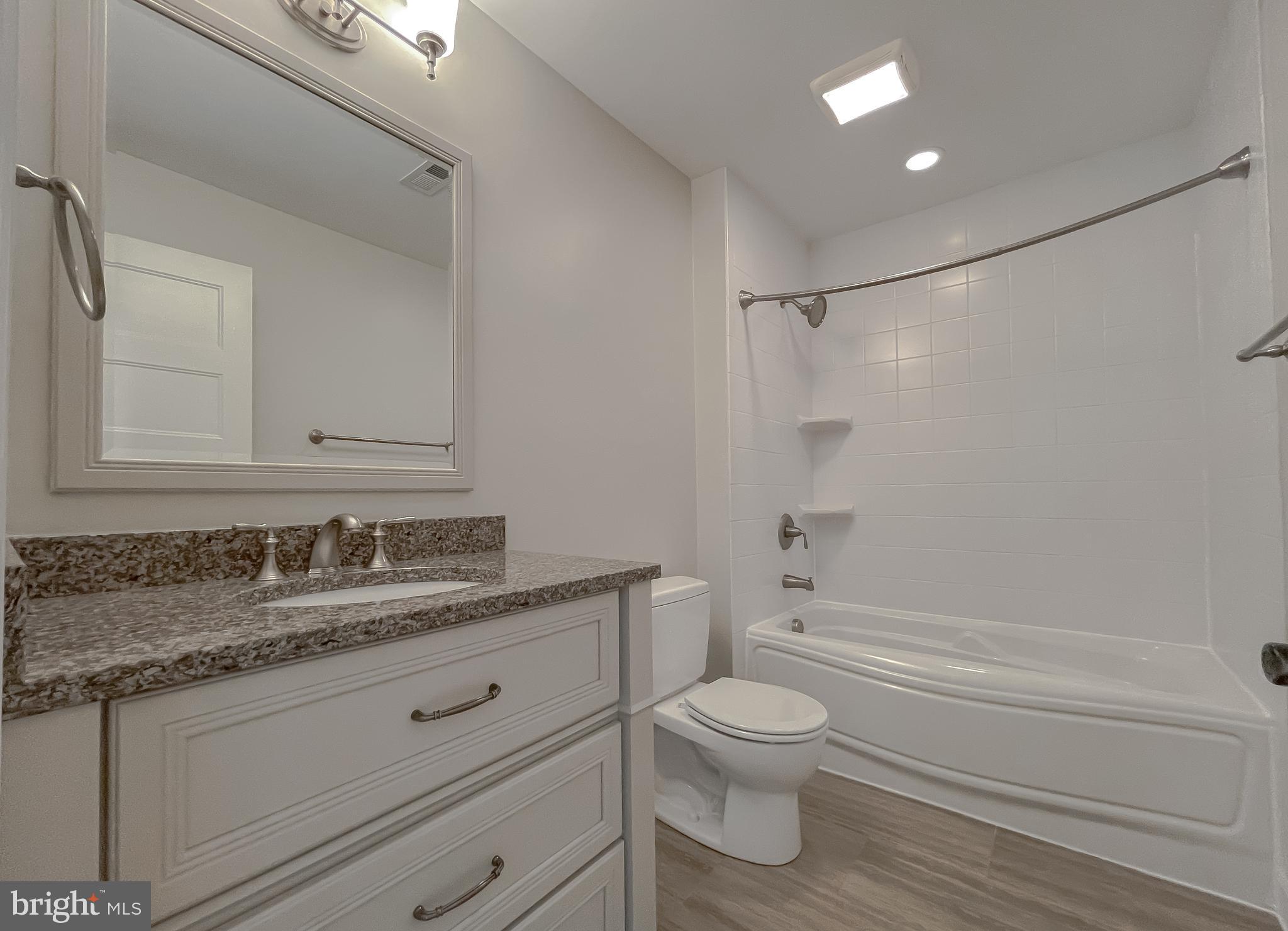24754 Half Pone Point Road Hollywood, MD 20636 - Photo 74 of 137 a bathroom with a granite countertop sink toilet and shower