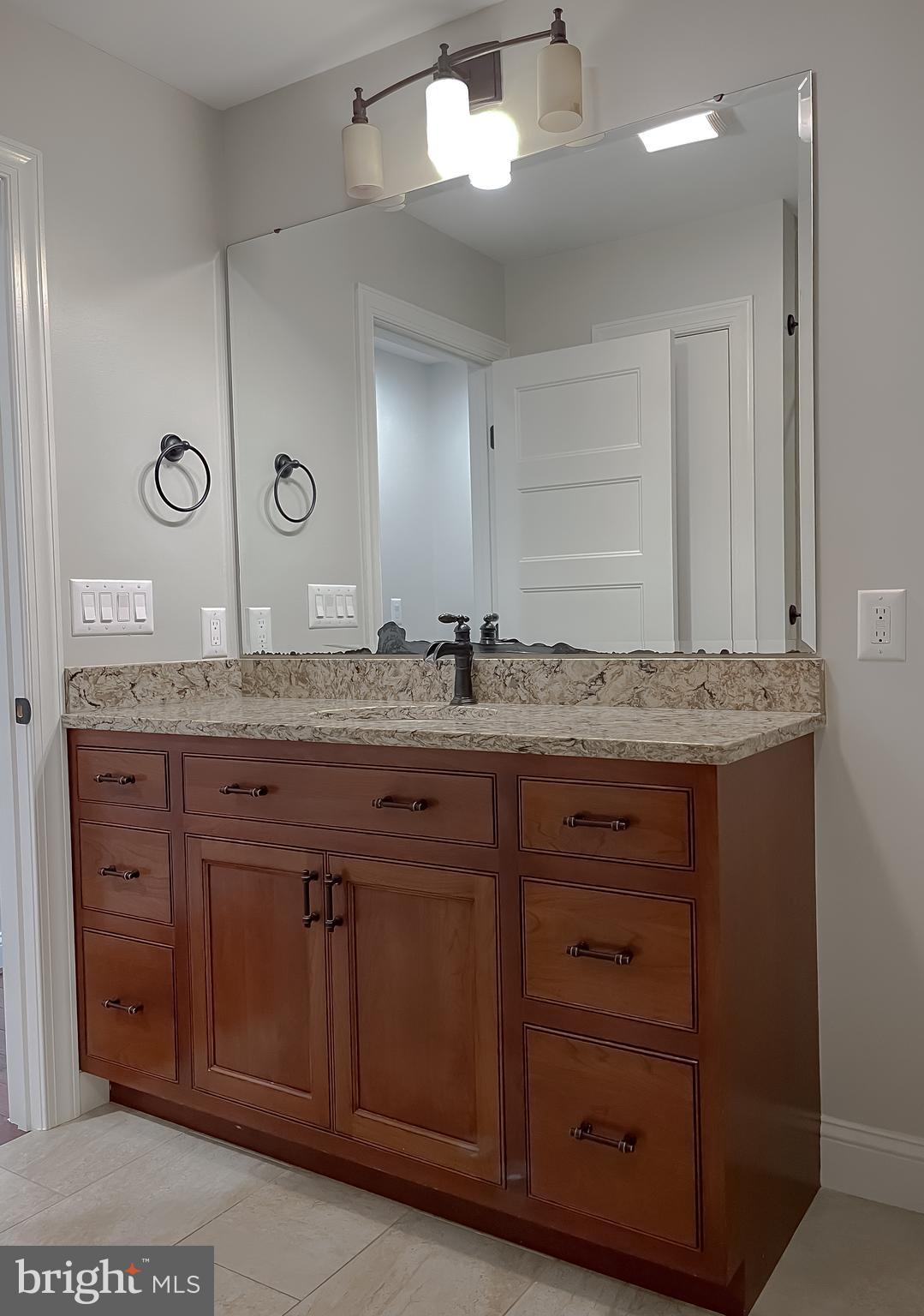 24754 Half Pone Point Road Hollywood, MD 20636 - Photo 86 of 137 a bathroom with a granite countertop sink and a mirror