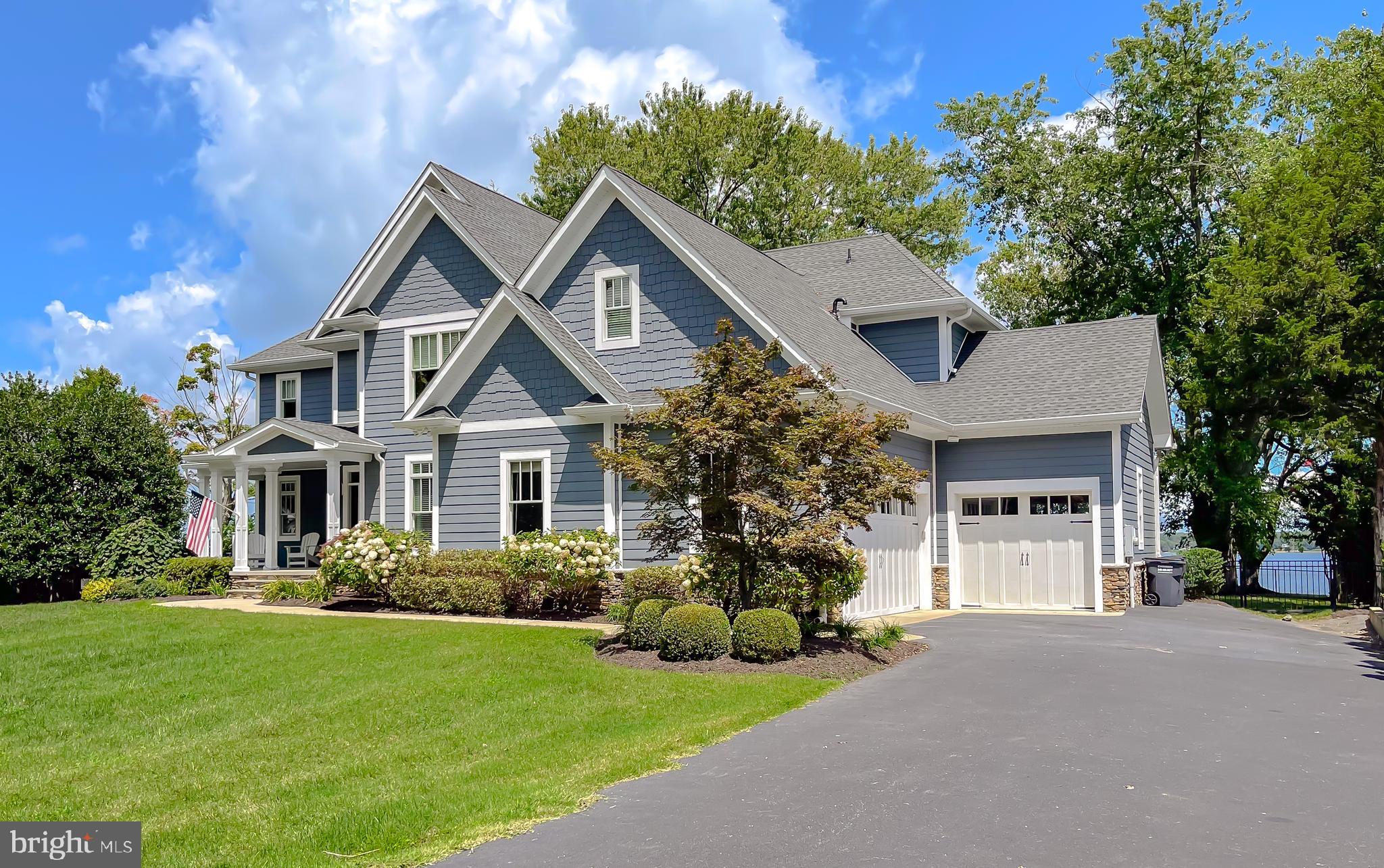 24754 Half Pone Point Road Hollywood, MD 20636 - Photo 9 of 137 a front view of a house with a yard and garage