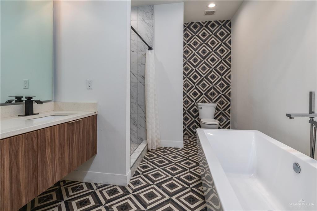 915 Santa Lucia Street Mission, TX 78572 - Photo 15 of 23 Bathroom with a stall shower, a freestanding bath, vanity, and recessed lighting