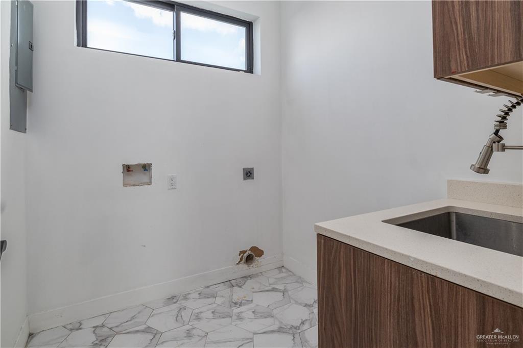 915 Santa Lucia Street Mission, TX 78572 - Photo 17 of 23 Laundry area featuring cabinet space, electric dryer hookup, and hookup for a washing machine