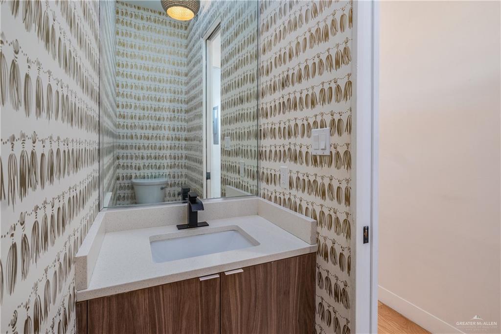 915 Santa Lucia Street Mission, TX 78572 - Photo 18 of 23 Half bath featuring vanity and wallpapered walls