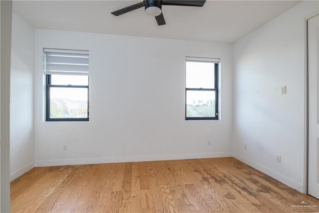 915 Santa Lucia Street Mission, TX 78572 - Photo 19 of 23 Empty room featuring light wood-style floors, plenty of natural light, and ceiling fan