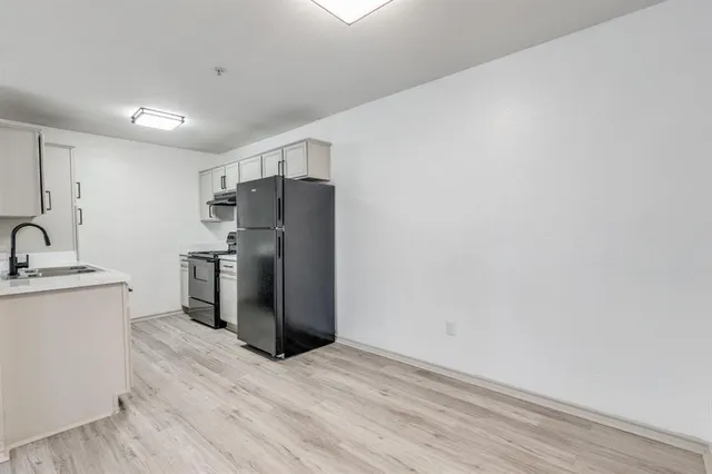 a kitchen with stainless steel appliances a refrigerator and a sink