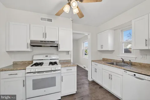 a kitchen with appliances cabinets and a sink