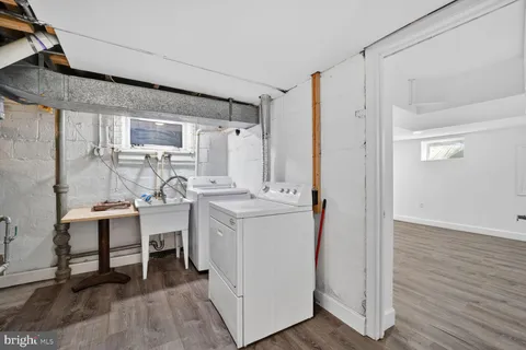 a kitchen with a sink cabinets and wooden floor