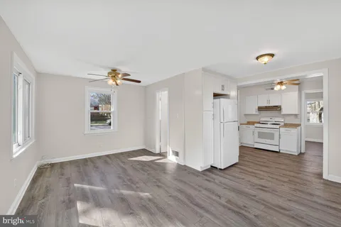 a view of kitchen with wooden floor and electronic appliances