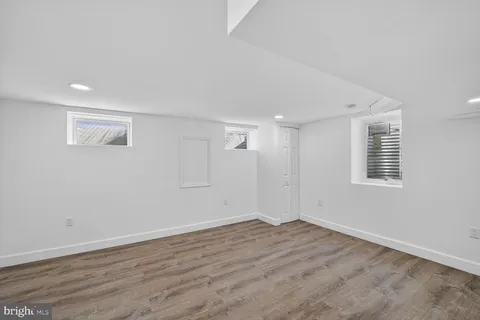 a view of a room with wooden floor and window