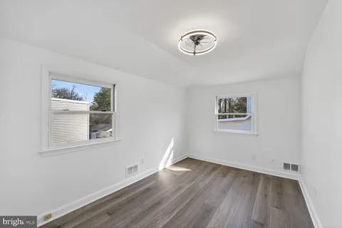 a view of a room with wooden floor and window