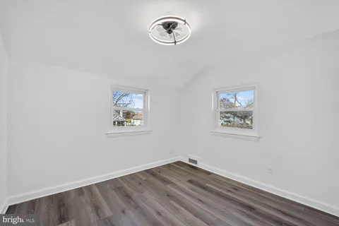 a view of room with hardwood floor and window