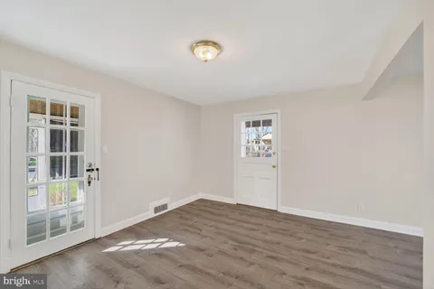 a view of a livingroom with wooden floor and window