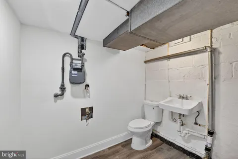 a bathroom with a toilet sink and mirror