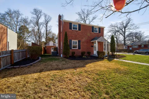 a brick house with a yard covered in snow