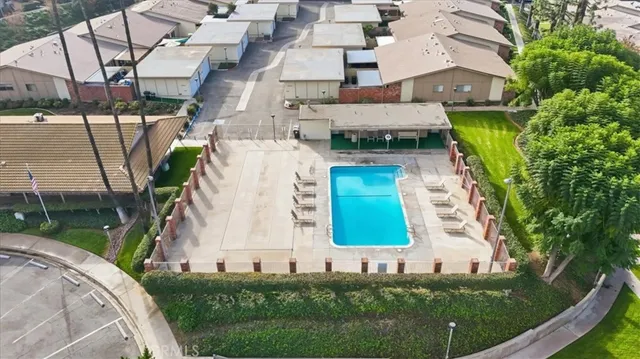 an aerial view of a house with a garden and trees