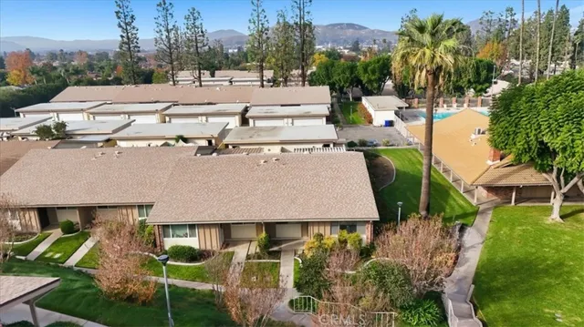 a view of a house with a yard and sitting area