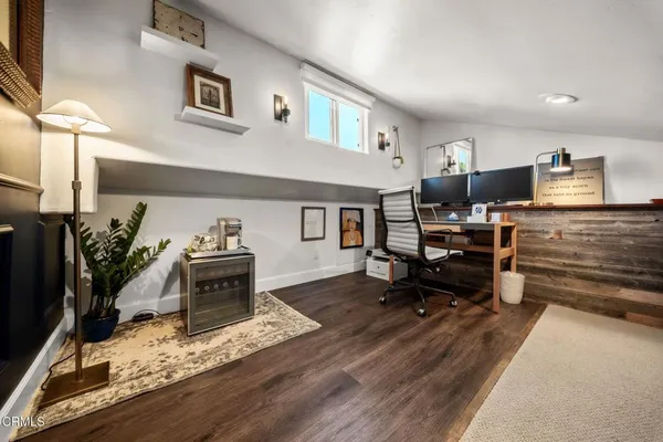 a living room with furniture flat screen tv and gym equipment