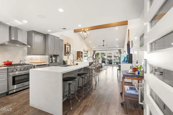 a kitchen with cabinets and wooden floor