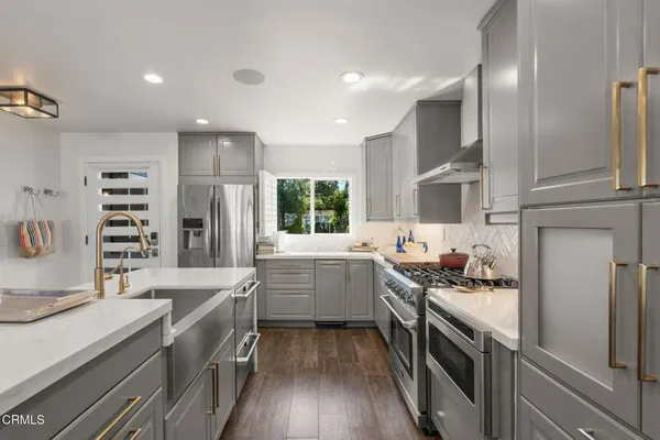 a kitchen with a sink stove and cabinets