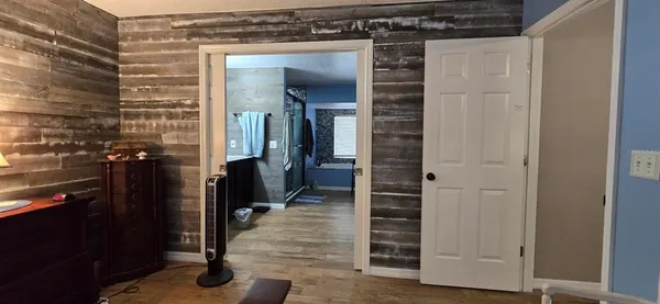 a living room with furniture a flat screen tv and a window