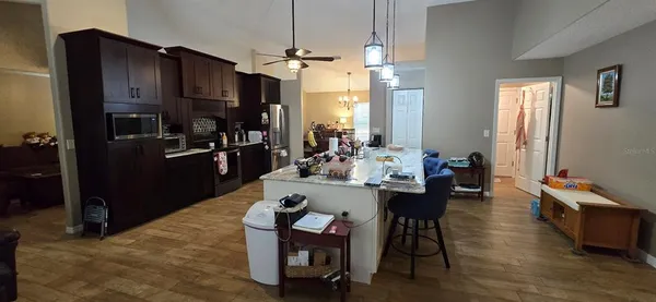 a view of a livingroom with furniture and a ceiling fan