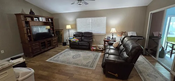 a living room with furniture and a wooden floor