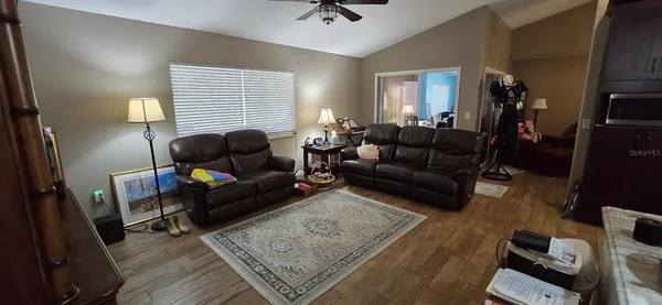 a view of a livingroom with furniture and hardwood floor