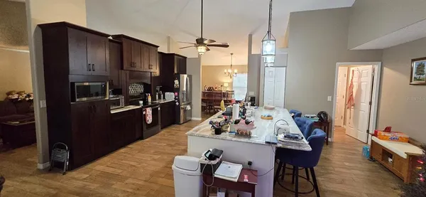 a kitchen with stainless steel appliances granite countertop a refrigerator a stove and a refrigerator