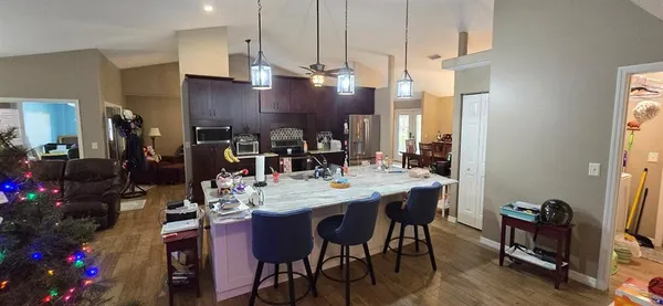 a view of a dining room with furniture and wooden floor