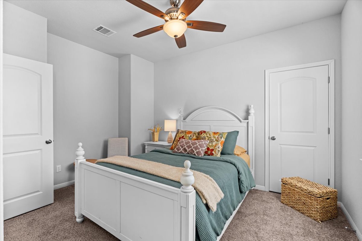 2733 Painted Sky Bend Leander, TX 78641 - Photo 26 of 35 a bedroom with a bed and a chandelier