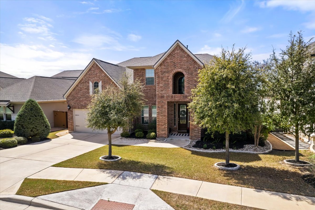 2733 Painted Sky Bend Leander, TX 78641 - Photo 3 of 35 a front view of a house with a yard
