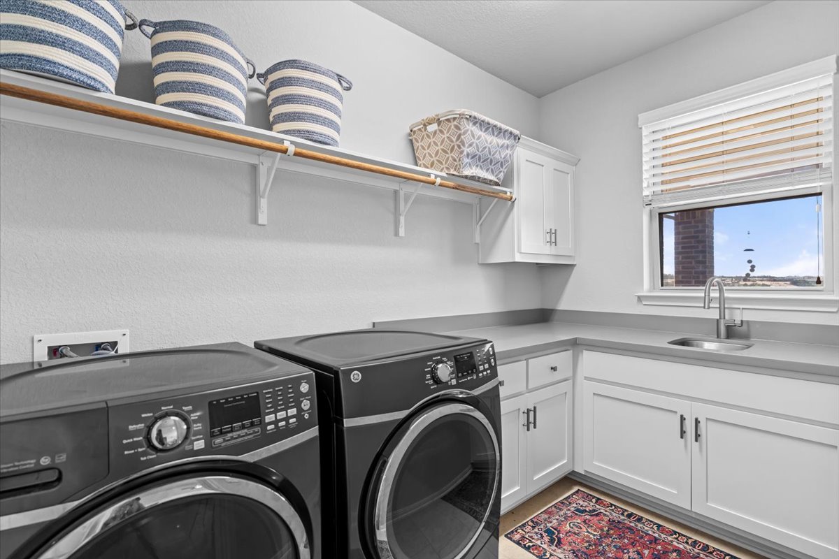 2733 Painted Sky Bend Leander, TX 78641 - Photo 31 of 35 a utility room with dryer and washer
