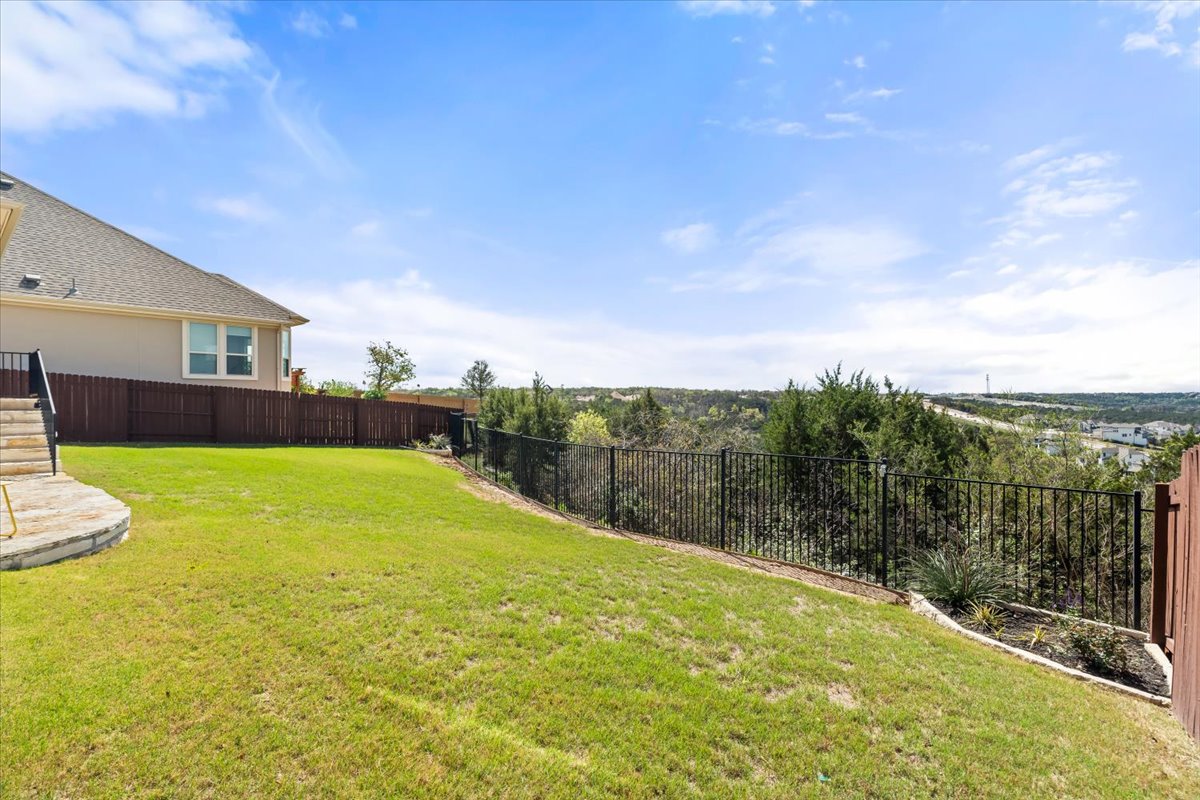 2733 Painted Sky Bend Leander, TX 78641 - Photo 34 of 35 a view of a backyard with plants and lake view