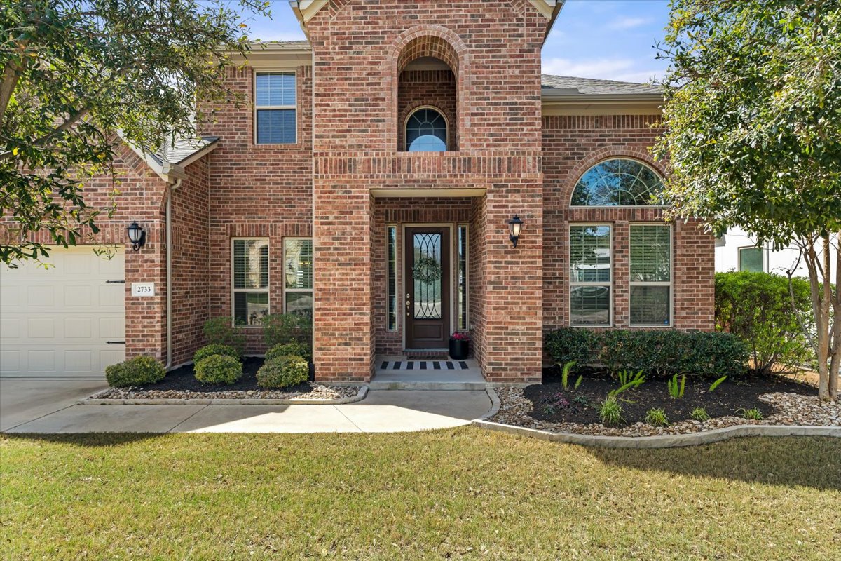 2733 Painted Sky Bend Leander, TX 78641 - Photo 4 of 35 a front view of a house with yard