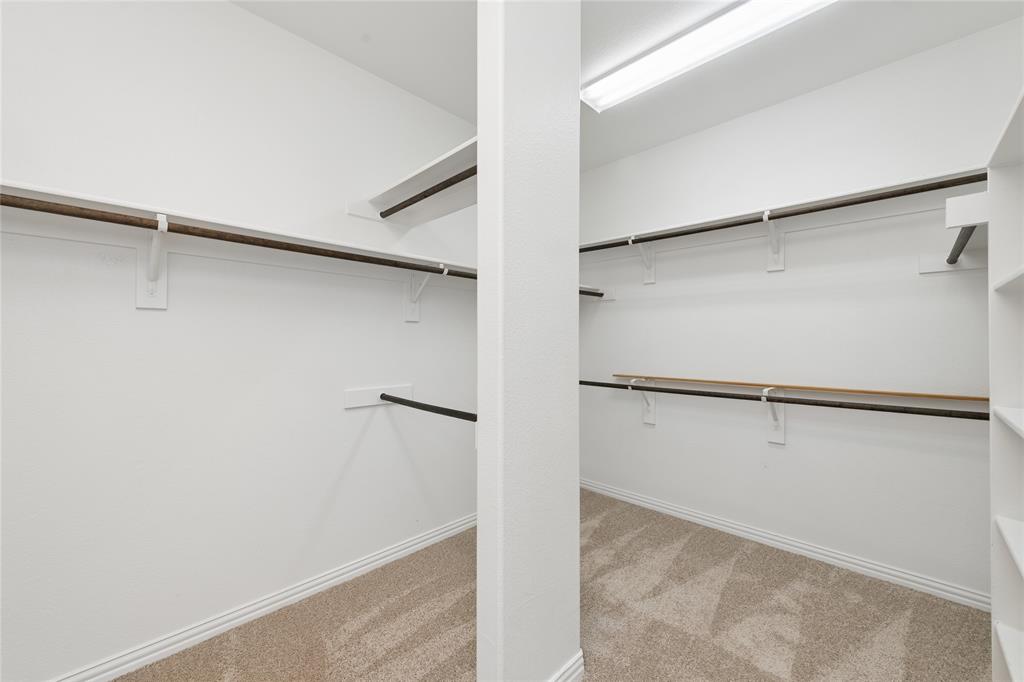 12571 Valley Spring Drive Frisco, TX 75035 - Photo 24 of 39 a view of walk in closet with empty racks