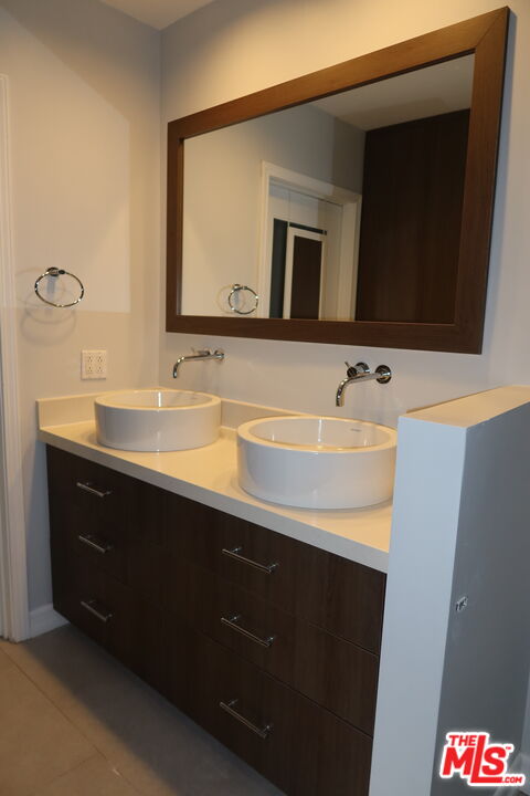 1617 Roscomare Road Los Angeles, CA 90077 - Photo 12 of 12 a bathroom with a sink and a mirror