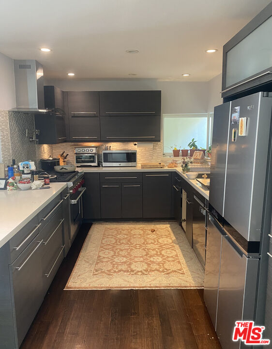 1617 Roscomare Road Los Angeles, CA 90077 - Photo 3 of 12 a kitchen with stainless steel appliances granite countertop a sink counter space and cabinets