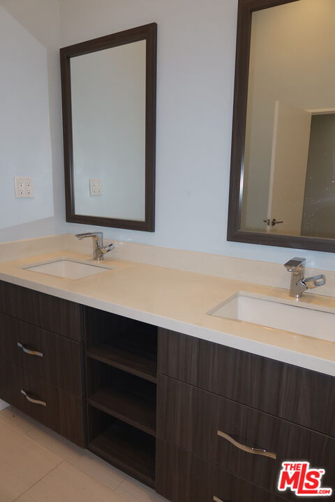 1617 Roscomare Road Los Angeles, CA 90077 - Photo 7 of 12 a bathroom with a sink vanity and a mirror