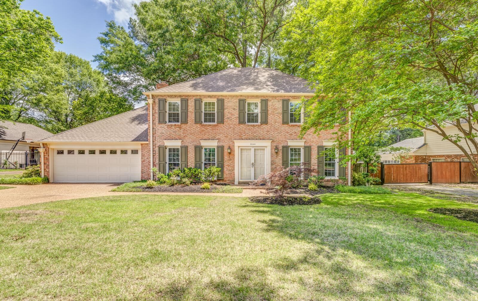 2044 Allenby Road Germantown, TN 38139 - Photo 1 of 40 View of front of house featuring driveway, brick siding, a garage, a shingled roof, and a chimney
