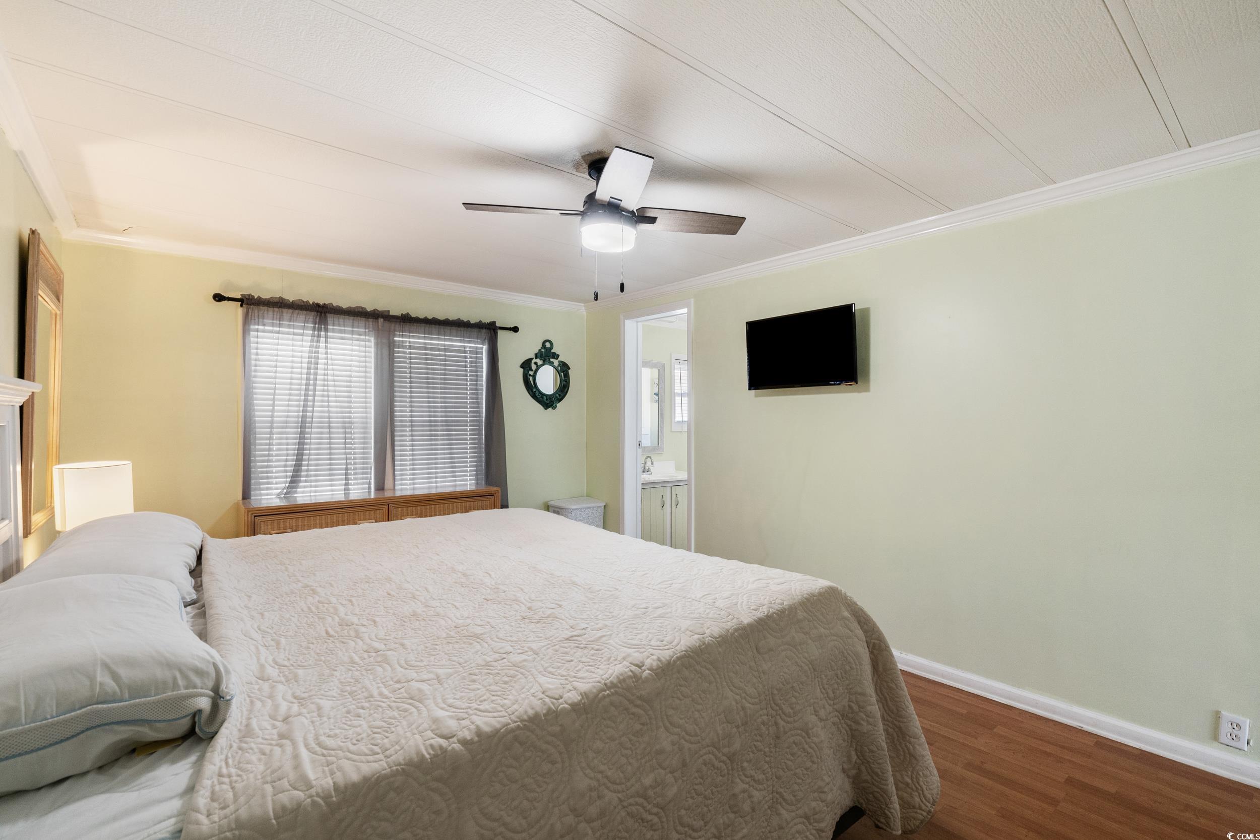 2003 Bittern Drive Myrtle Beach, SC 29575 - Photo 13 of 40 Bedroom featuring ornamental molding, ensuite bath, ceiling fan, and wood-type flooring