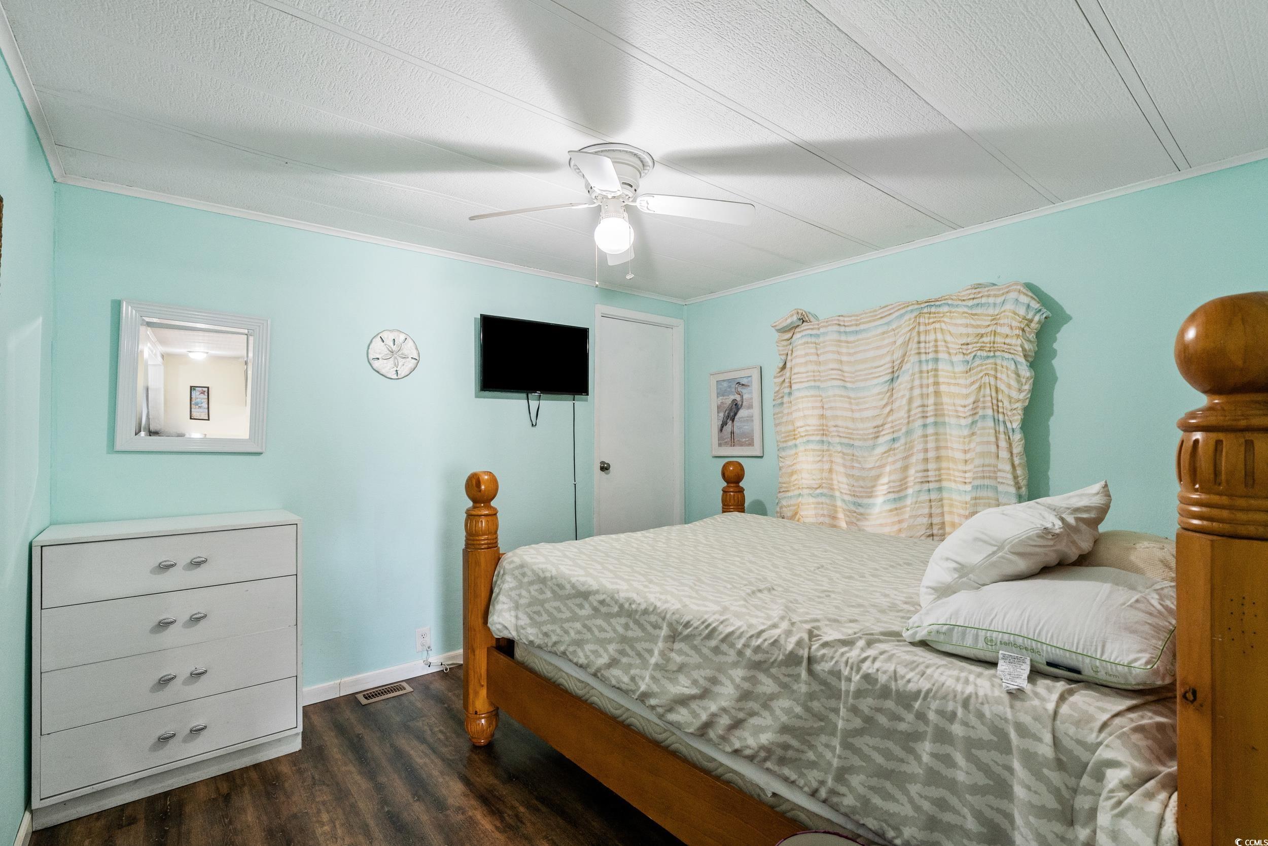 2003 Bittern Drive Myrtle Beach, SC 29575 - Photo 14 of 40 Bedroom with dark wood-type flooring, crown molding, a textured ceiling, and ceiling fan