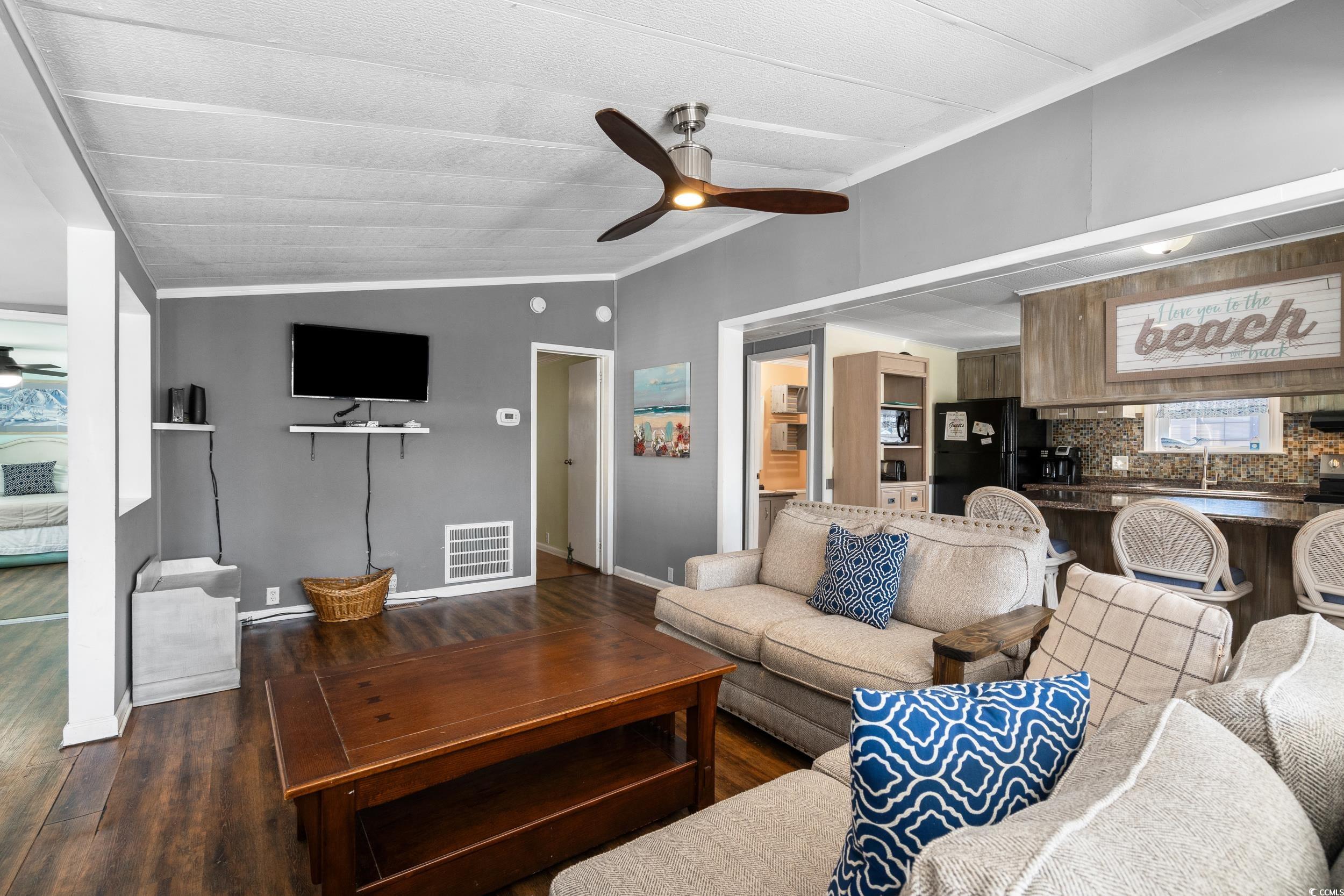 2003 Bittern Drive Myrtle Beach, SC 29575 - Photo 2 of 40 Living room featuring ceiling fan, lofted ceiling, sink, dark wood-type flooring, and crown molding